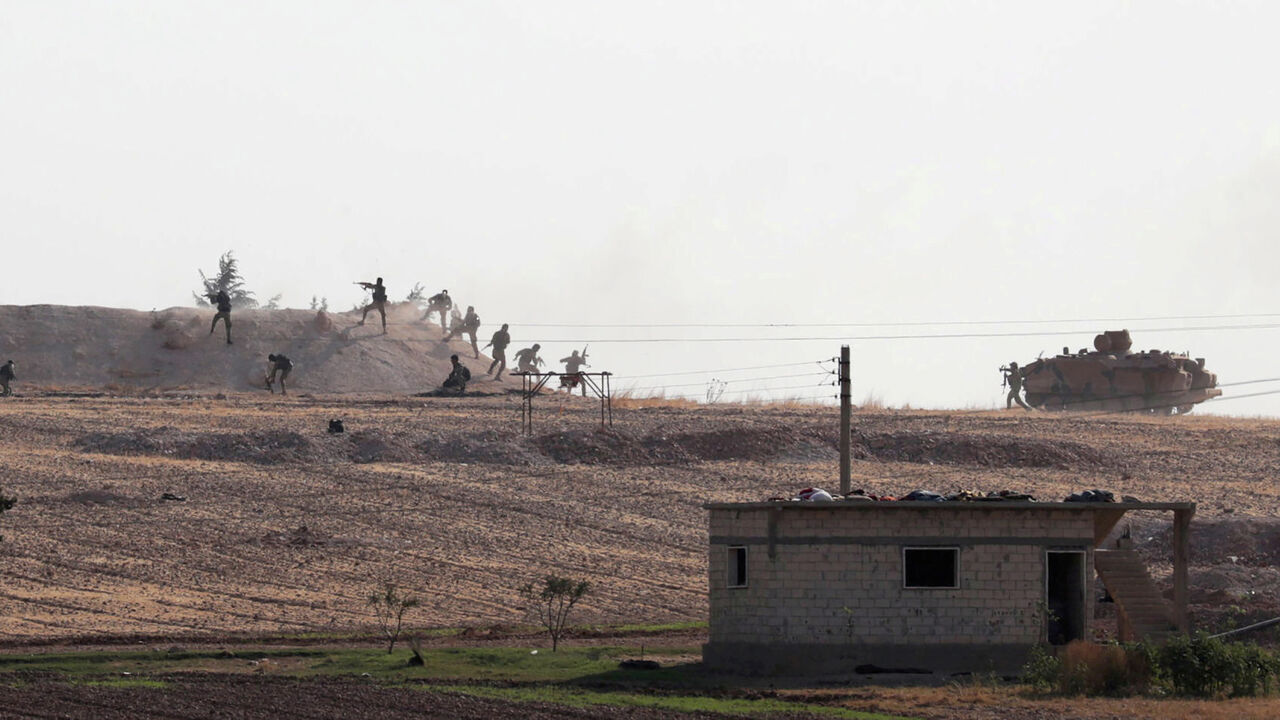 GLOBAL-POY/ Turkey-backed Syrian rebel fighters are seen in action in the village of Yabisa, near the Turkish-Syrian border, Syria, October 13, 2019. REUTERS/Khalil Ashawi/File Photo SEARCH "GLOBAL POY" FOR THIS STORY. SEARCH "REUTERS POY" FOR ALL BEST OF 2019 PACKAGES. TPX IMAGES OF THE DAY. - RC2GOD9M52J9