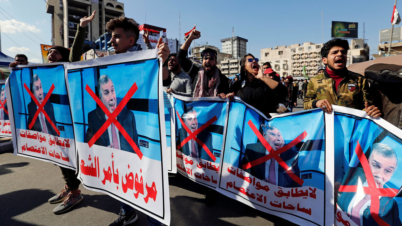 IRAQ-PROTESTS/ Iraqi demonstrators and university students carry posters depicting the newly appointed Prime Minister of Iraq, Mohammed Tawfiq Allawi, to express their rejection of him, during ongoing anti-government protests in Baghdad, Iraq February 2, 2020. REUTERS/Wissm al-Okili - RC2CSE9SET8I