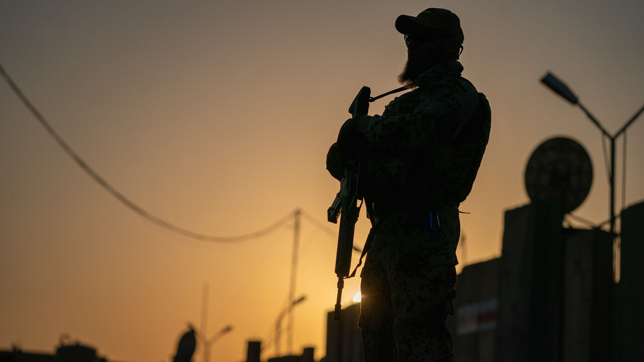 1162879350 20 August 2019, Iraq, Bagdad: A soldier of the German Armed Forces is standing at dusk with his weapon on the verge of the German Defence Minister's visit to the international military camp Camp Taji. The minister and CDU leader is conducting political talks in the capital Baghdad and is meeting German soldiers who are involved in training local forces in the country. Photo: Michael Kappeler/dpa (Photo by Michael Kappeler/picture alliance via Getty Images)