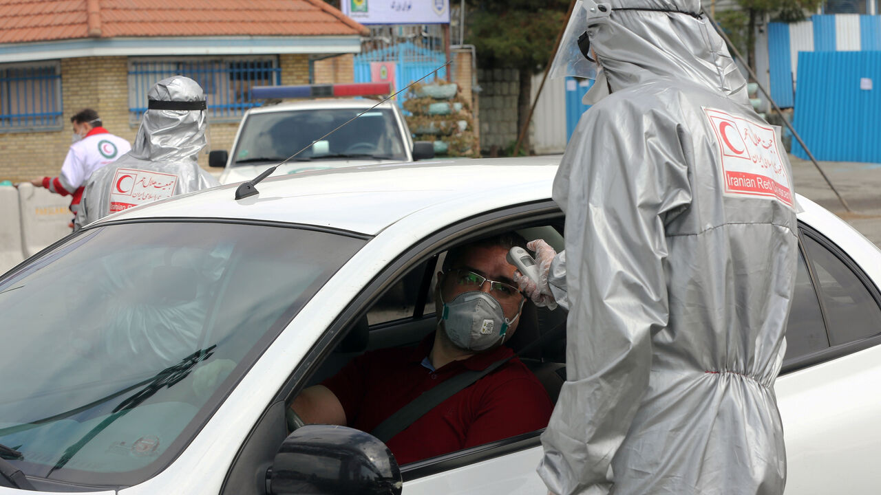 1208280248 TEHRAN, IRAN - MARCH 26: Health officials check body temperature of drivers and passengers at the entrance of the capital Tehran as travel ban across the country was issued within the precaution against coronavirus (Covid-19) outbreak in Tehran, Iran on March 26, 2020. (Photo by Fatemeh Bahrami/Anadolu Agency via Getty Images)