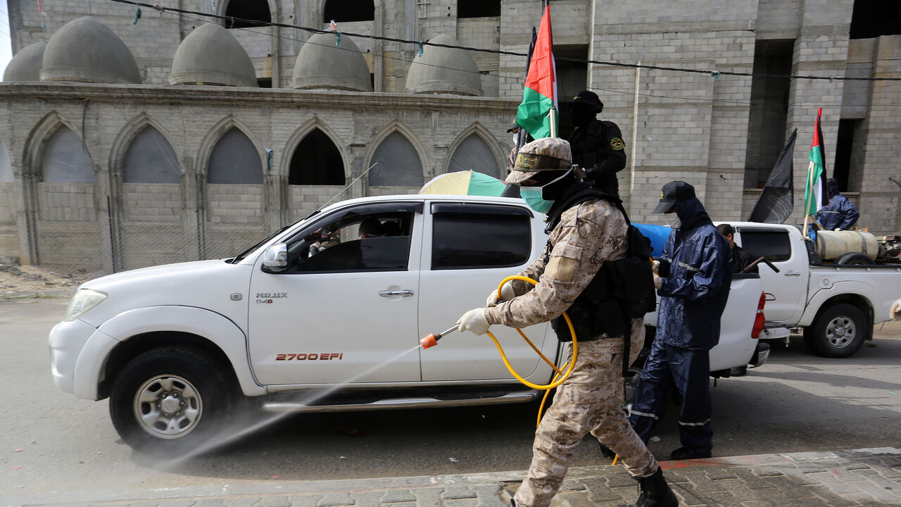 1208284588 RAFAH, GAZA â MARCH 26: Members of Saraya al-Quds, armed wing of the Palestinian Islamic Jihad, carry out disinfection works as a preventive measure against the coronavirus (COVID-19) pandemic in Rafah, Gaza on March 26, 2020. (Photo by Abed Rahim Khatib/Anadolu Agency via Getty Images)