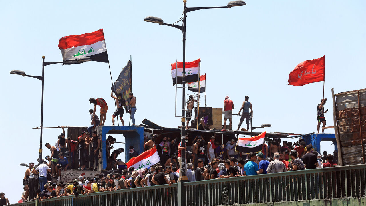 1212451103 BAGHDAD, IRAQ - MAY 10: Iraqi security forces intervene Iraqi demonstrators with tear gas canisters and water cannons during a protest as the protests have started again after a break due to novel coronavirus (COVID-19) measures, at Tahrir Square in Baghdad, Iraq on May 10, 2020. (Photo by Murtadha Al-Sudani/Anadolu Agency via Getty Images)