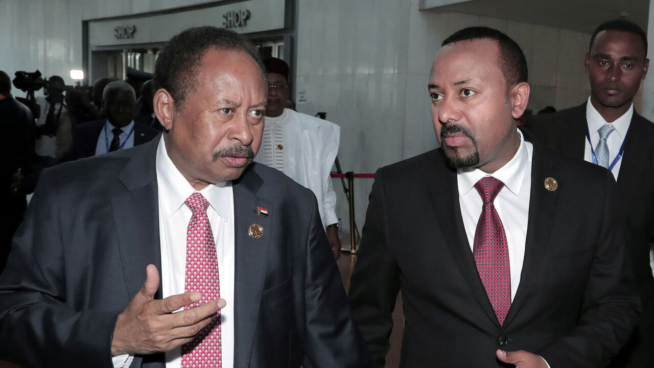 AFRICANUNION-SUMMIT/ Sudan's Prime Minister Abdalla Hamdok and Ethiopia's Prime Minister Abiy Ahmed arrive for the opening of the 33rd Ordinary Session of the Assembly of the Heads of State and the Government of the African Union (AU) in Addis Ababa, Ethiopia, February 9, 2020. REUTERS/Tiksa Negeri - RC21XE9C5IAK