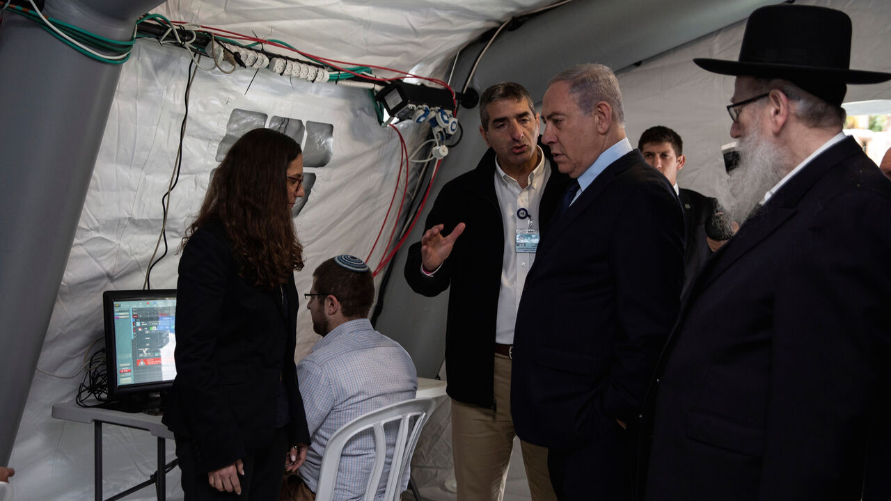CHINA-HEALTH/ISRAEL-NETANYAHU Israeli Prime Minister Benjamin Netanyahu arrives to a tent during his visit to the Chaim Sheba Medical Center at Tel Hashomer in Ramat Gan, Israel, for discussion on the coronavirus, February 19, 2020. Heidi Levine/Poolvia REUTERS - RC2N3F92AZM9