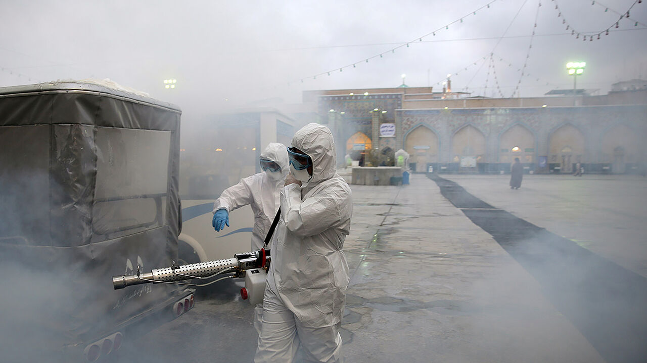 Members of the medical team spray disinfectant to sanitize outdoor place of Imam Reza's holy shrine, following the coronavirus outbreak, in Mashhad, Iran February 27, 2020. Picture taken February 27, 2020. WANA (West Asia News Agency) via REUTERS ATTENTION EDITORS - THIS PICTURE WAS PROVIDED BY A THIRD PARTY - RC2FAF9ALELI