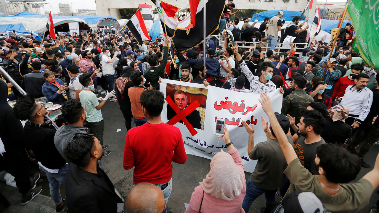 IRAQ-PROTESTS/ Iraqi demonstrators carry a poster depicting the Prime Minister of Iraq, Mohammed Tawfiq Allawi, to express their rejection of him, during ongoing anti-government protests in Baghdad, Iraq March 1, 2020. REUTERS/Wissam al-Okaili - RC21BF9IG5VT