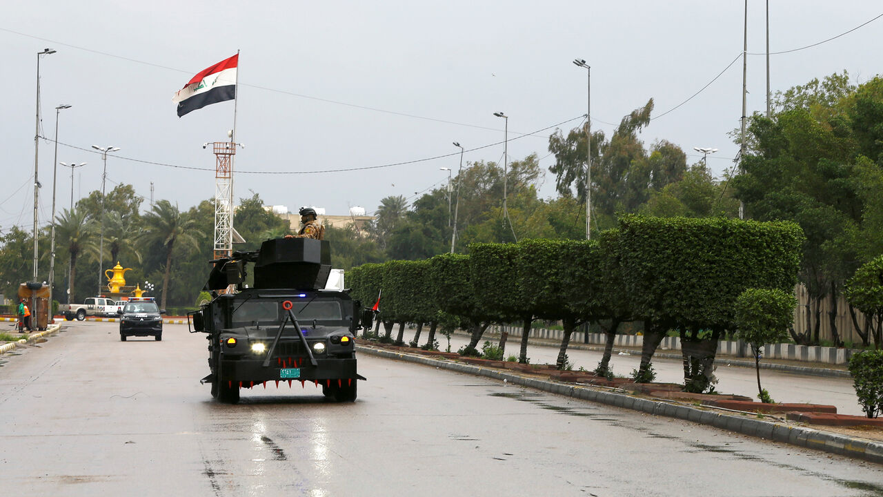 HEALTH-CORONAVIRUS/IRAQ-BAGHDAD Iraqi security forces patrol a street, during a curfew imposed to prevent the spread of coronavirus disease (COVID-19), in Baghdad, Iraq March 18, 2020. REUTERS/Thaier Al-Sudani - RC2CMF94NO5Z