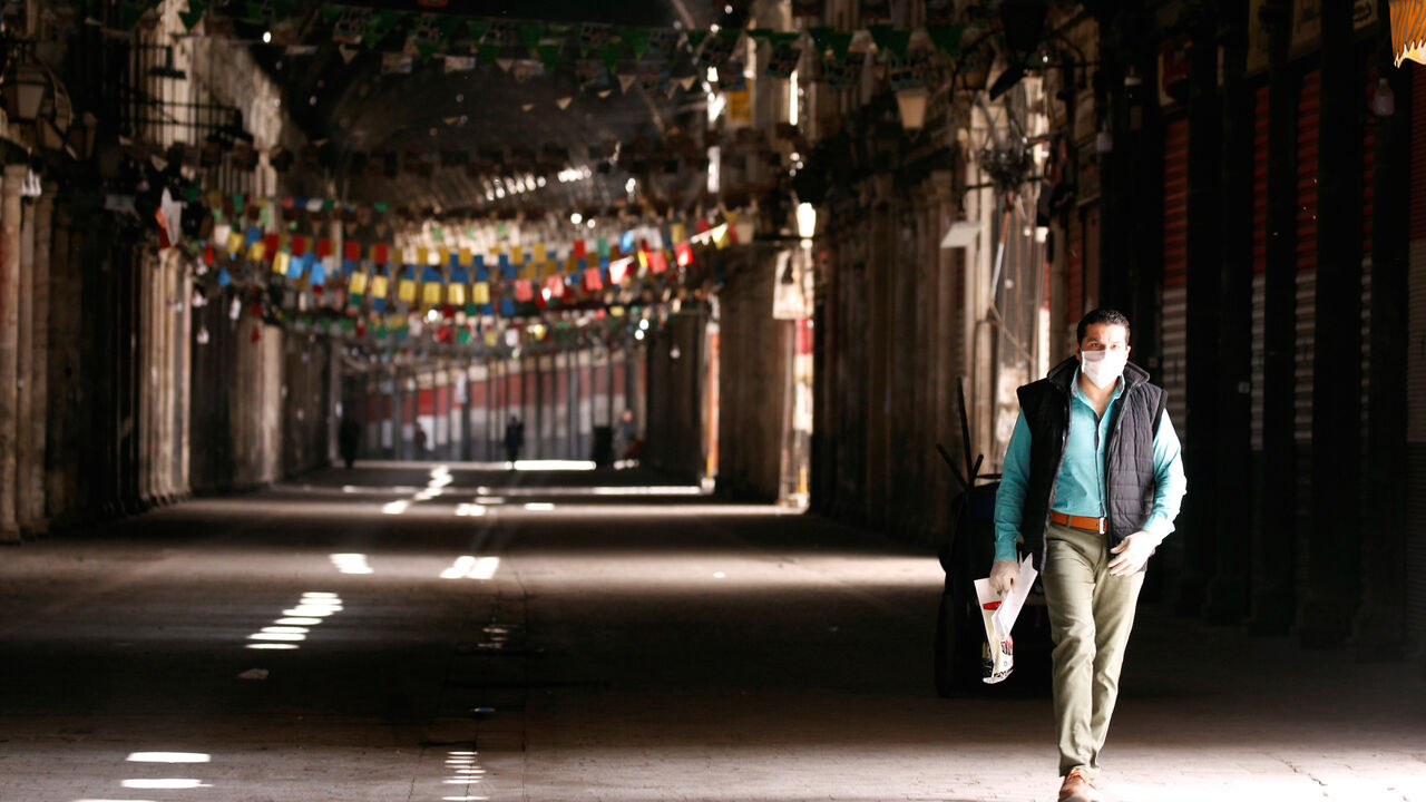HEALTH-CORONAVIRUS/SYRIA A man walks in empty Souk al-Hamidieh as restrictions are imposed as measure to prevent the spread of the coronavirus disease (COVID-19) in Damascus, Syria March 24, 2020. REUTERS/Omar Sanadiki - RC2HQF96TEGY