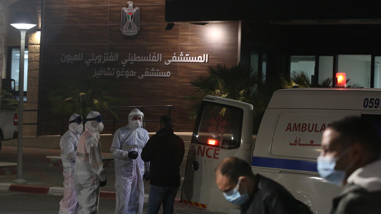 1209369972 RAMALLAH, WEST BANK - APRIL 07: Health Care Personnel are seen as 11 patients, infected with novel coronavirus (COVID-19), are being discharged from the Hugo Chavez Hospital following their full recovery, at Turmus Ayya town, northeast of Ramallah in West Bank on April 07, 2020. (Photo by Issam Rimawi/Anadolu Agency via Getty Images)