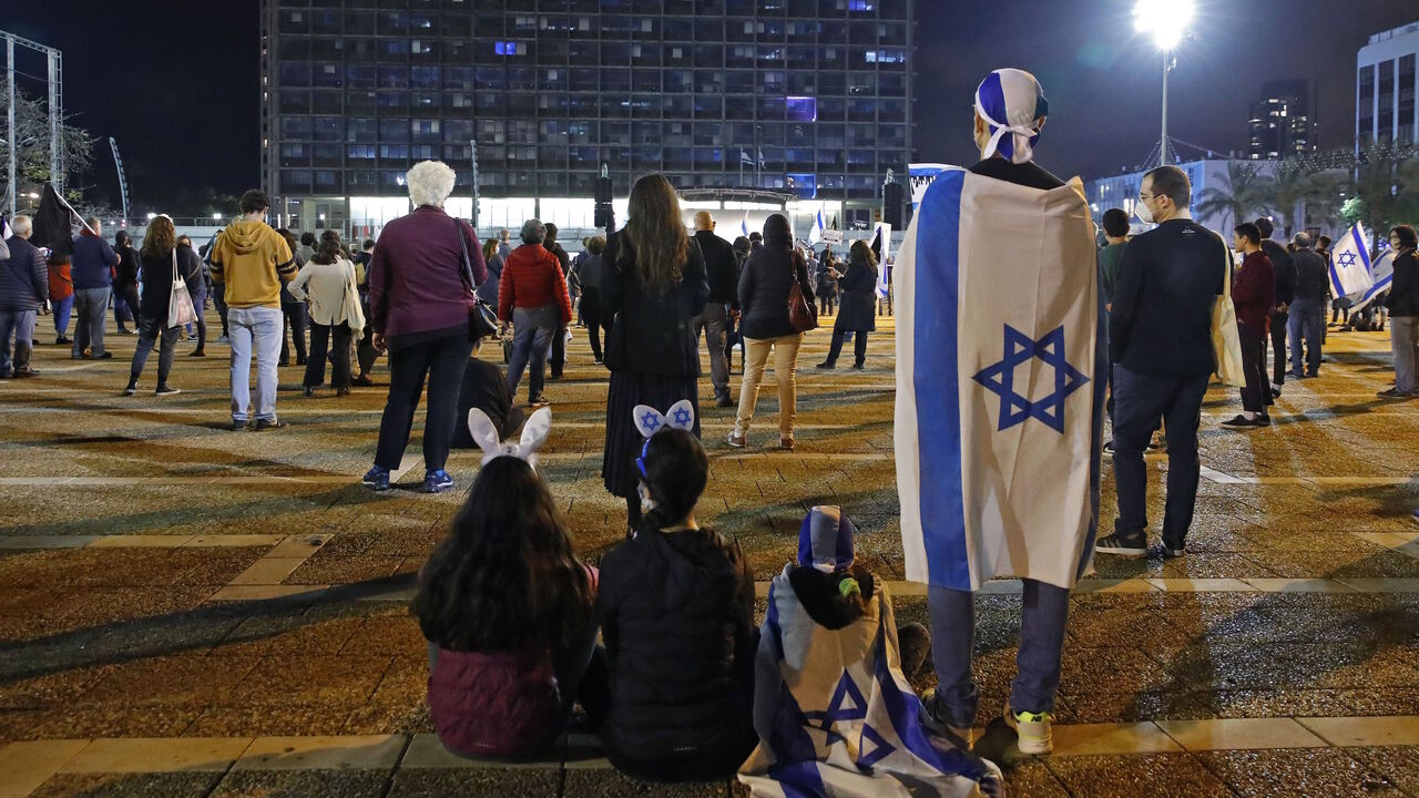 1211014867 Israelis take part in a demonstration on April 25, 2020, in Rabin Square in the coastal city of Tel Aviv, to protest what they consider threats to Israeli democracy, against the backdrop of negotiations between Prime Minister Benjamin Netanyahu and his ex-rival Benny Gantz. - The protesters stood two meters apart from each other, thereby respecting the social distancing measures in force to fight the COVID-19 pandemic. (Photo by JACK GUEZ / AFP) (Photo by JACK GUEZ/AFP via Getty Images)
