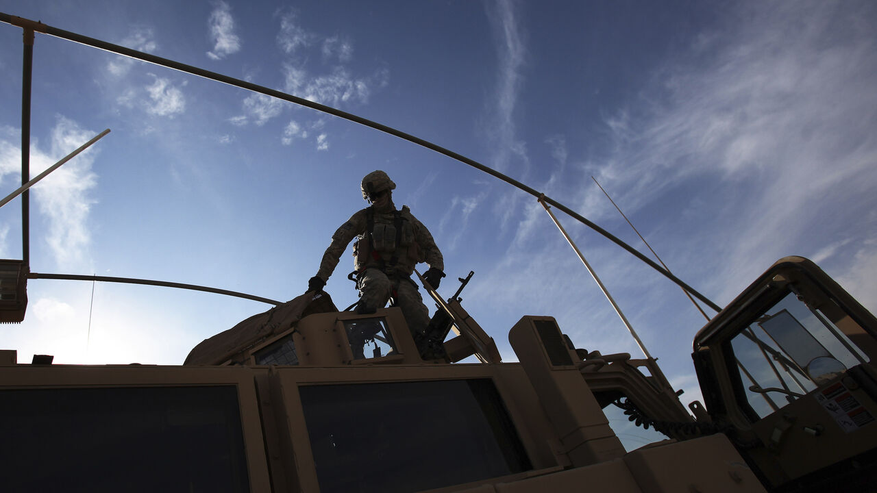 IRAQ-WITHDRAWAL/ A U.S. Army soldier from the 2nd Brigade 82nd Airborne Division gets out of his Mine Resistant Ambush Protected (MRAP) vehicle after arriving at Camp Kalsu near Hillla, December 5, 2011. The brigade arrived from Taji, which is 20 miles (32 km) north of Baghdad on route to withdrawal from Iraq. REUTERS/Shannon Stapleton (IRAQ - Tags: MILITARY CONFLICT) - GM1E7C60FJF01