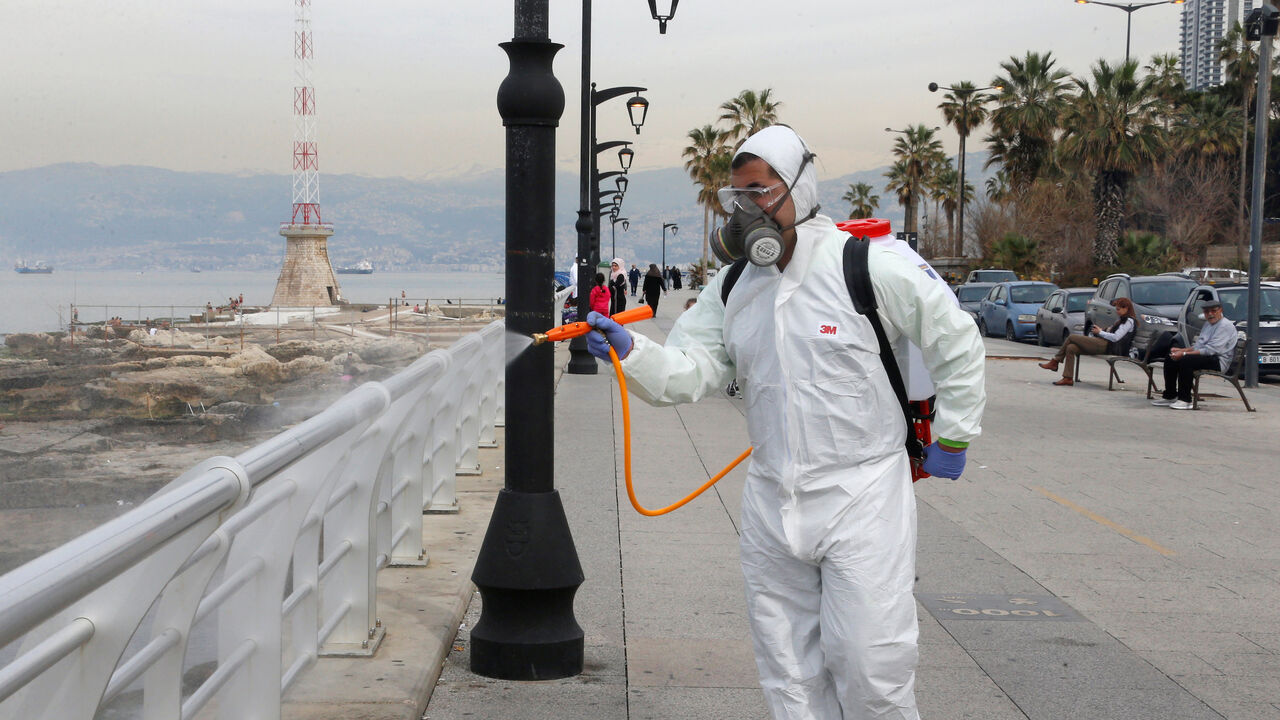 HEALTHCARE-CORONAVIRUS/LEBANON Employees from a disinfection company sanitize handrails, as a precaution against the spread of the coronavirus, at Beirut's seaside Corniche, Lebanon March 5, 2020. REUTERS/Mohamed Azakir - RC2SDF9YPMAO