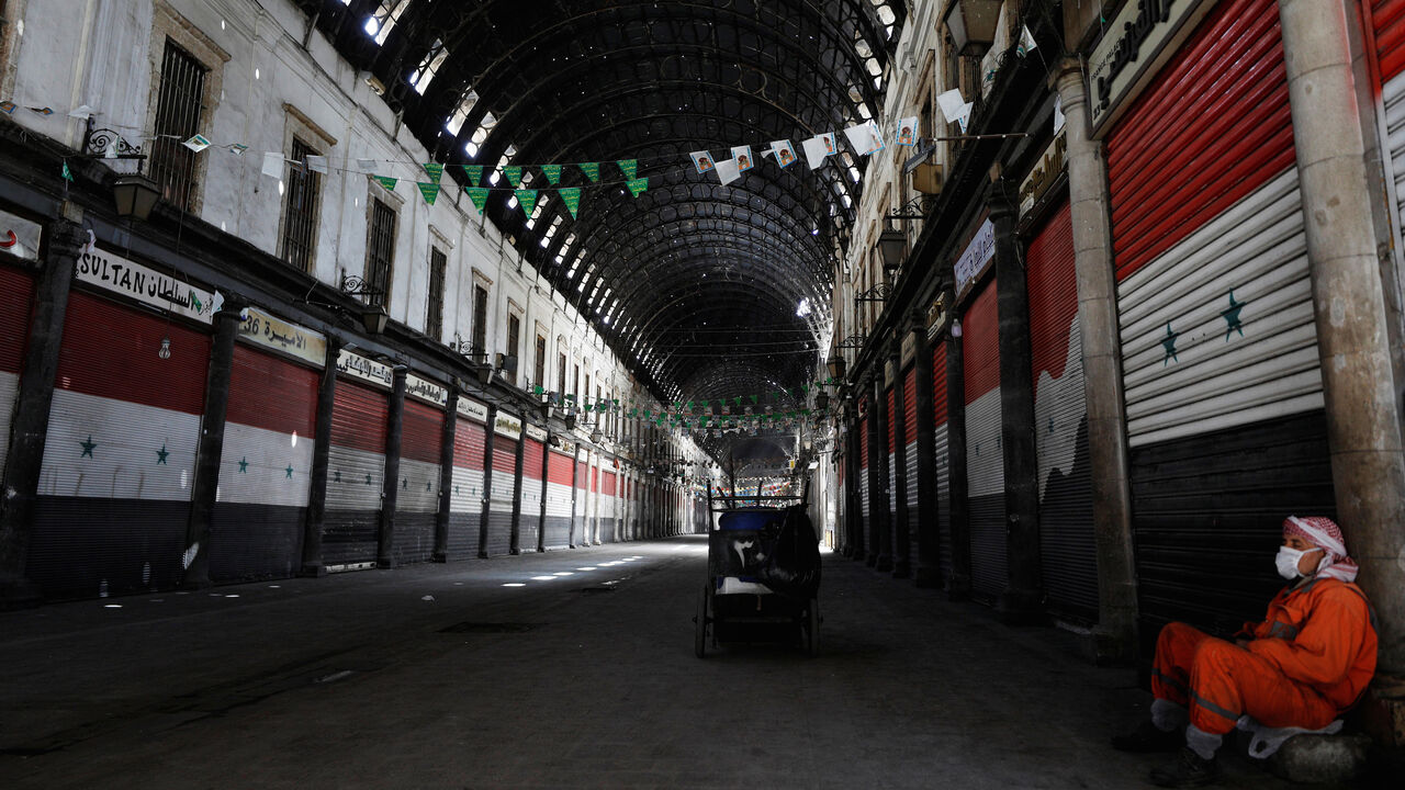 HEALTH-CORONAVIRUS/SYRIA A street cleaner rests at empty Souk al-Hamidieh, as restrictions are imposed as measure to prevent the spread of the coronavirus disease (COVID-19) in Damascus, Syria March 24, 2020. REUTERS/Omar Sanadiki - RC2HQF9TCDQH