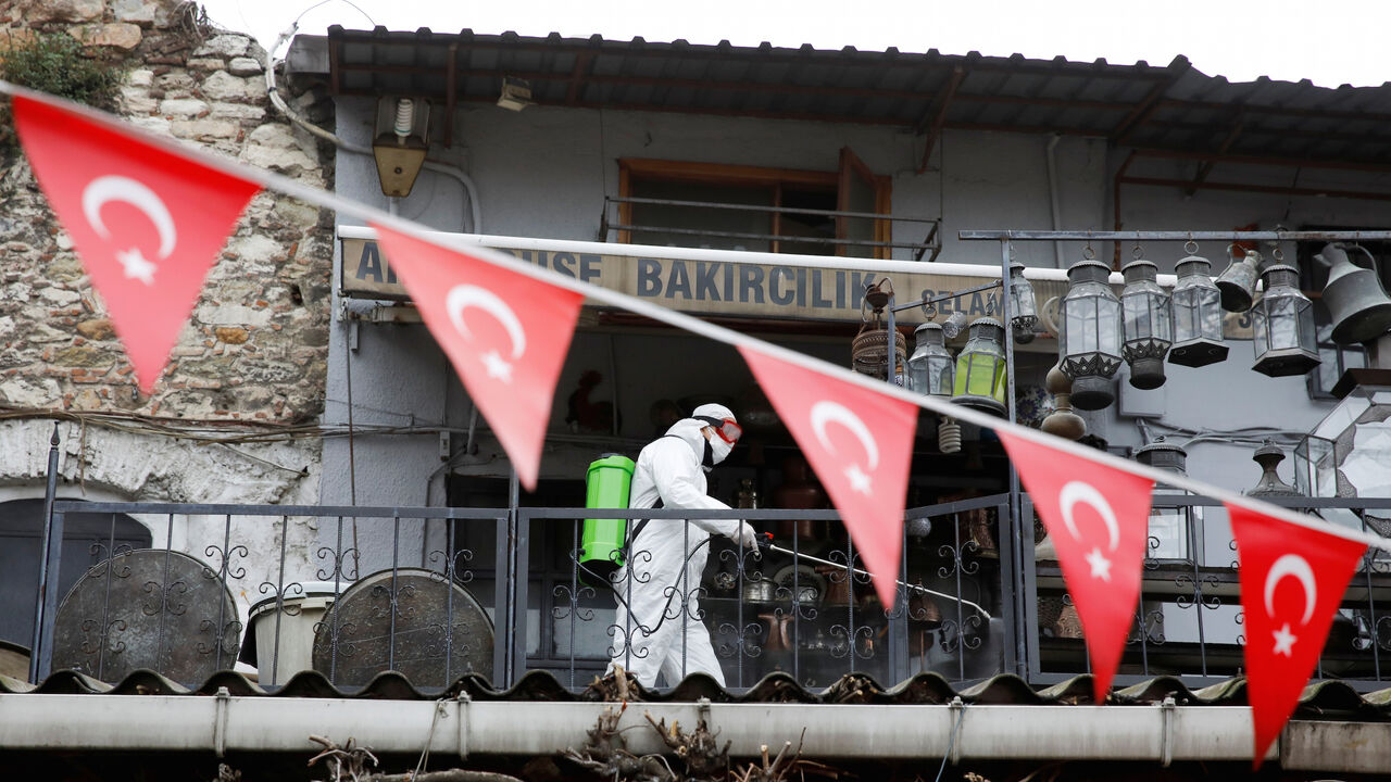 A worker in a protective suit sprays disinfectant at Grand Bazaar, known as the Covered Bazaar, to prevent the spread of coronavirus disease (COVID-19), in Istanbul, Turkey, March 25, 2020. REUTERS/Umit Bektas - RC2YQF9I7XRJ