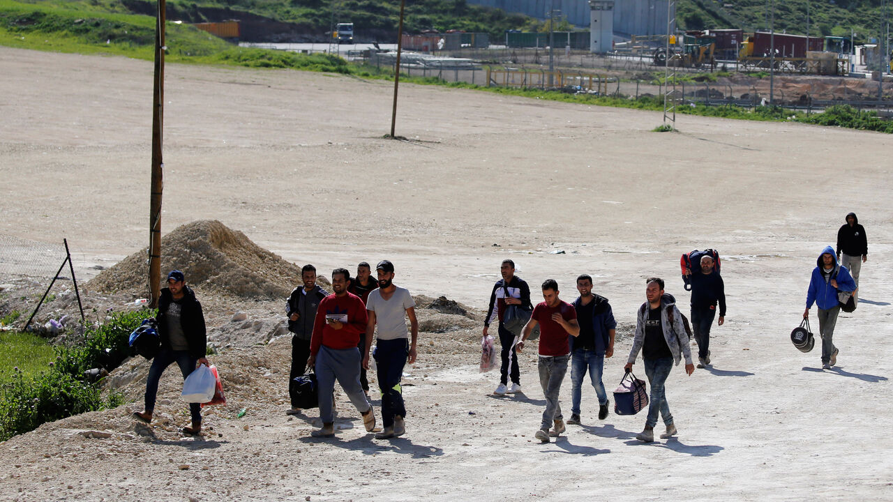HEALTH-CORONAVIRUS/ISRAEL-PALESTINIANS Palestinian workers returning from Israel arrive at a testing site for the coronavirus disease (COVID-19), outside the Israeli-controlled Tarqumiya checkpoint near Hebron in the Israeli-occupied West Bank March 26, 2020. REUTERS/Mussa Qawasma - RC2RRF9ZN4LX