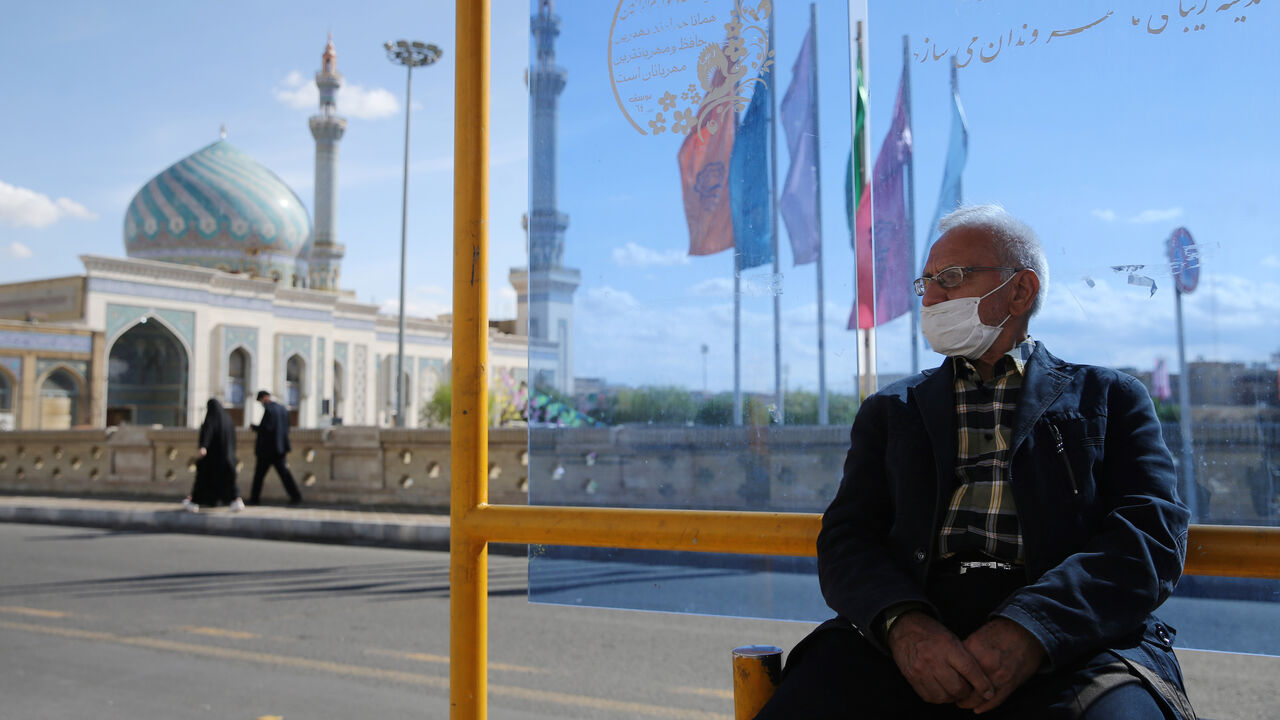 HEALTH-CORONAVIRUS/IRAN-QOM A man wearing a protective face mask, following the outbreak of coronavirus disease (COVID-19), sits at a bus stop in Qom, Iran March 24, 2020. Picture taken March 24, 2020. WANA (West Asia News Agency) via REUTERS ATTENTION EDITORS - THIS PICTURE WAS PROVIDED BY A THIRD PARTY - RC2BWF9JVDZM