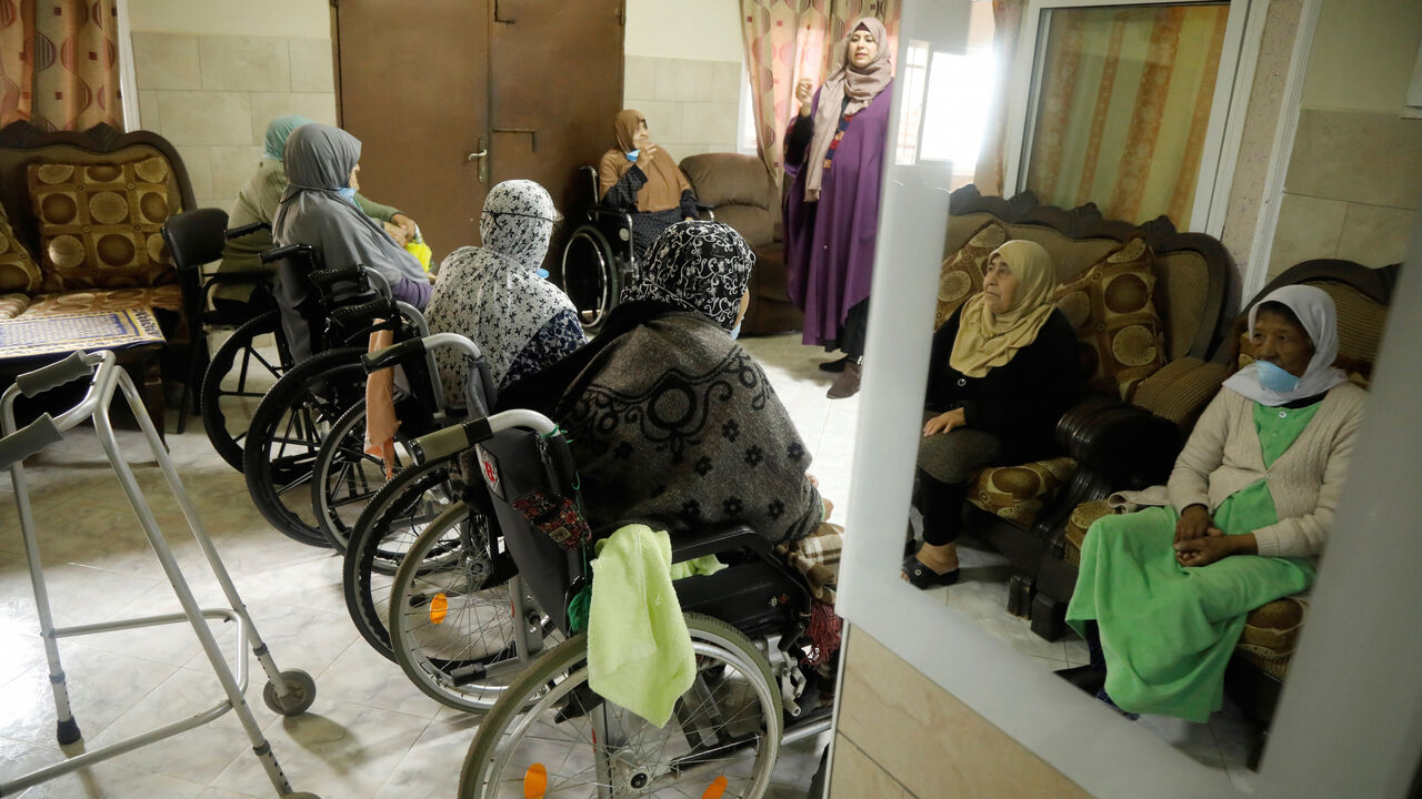 HEALTH-CORONAVIRUS/PALESTINIANS-ELDERLY Elderly Palestinian women are reflected in a mirror during an awareness lesson on coronavirus disease (COVID-19) in a nursing house that stepped up preventive measures to protect the patients, in Jenin in the Israeli-occupied West Bank, April 2, 2020. REUTERS/Raneen Sawafta - RC2CWF9971N2