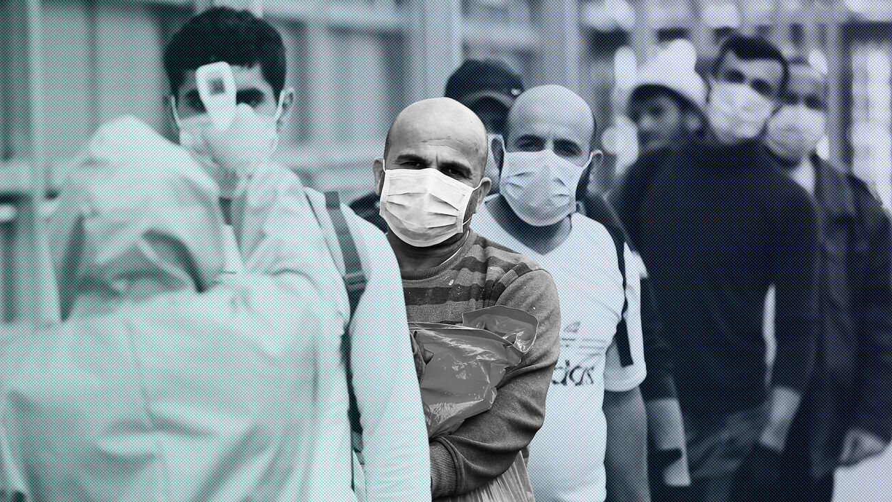 HEALTH-CORONAVIRUS/ISRAEL-PALESTINIANS A healthcare worker checks the body temperature of Palestinian workers returning from Israel, amid concerns over the spread of the coronavirus disease (COVID-19), outside the Israeli-controlled Meitar checkpoint, near Hebron in the Israeli-occupied West Bank April 7, 2020. Picture taken April 7, 2020. REUTERS/Mussa Qawasma - RC280G9AG6MG