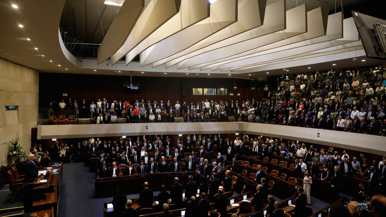 ISRAEL-ELECTION/PARLIAMENT Members of the 22nd Knesset, the Israeli parliament, stand during their swearing-in ceremony, in Jerusalem October 3, 2019. REUTERS/Ronen Zvulun - RC1172B0B270