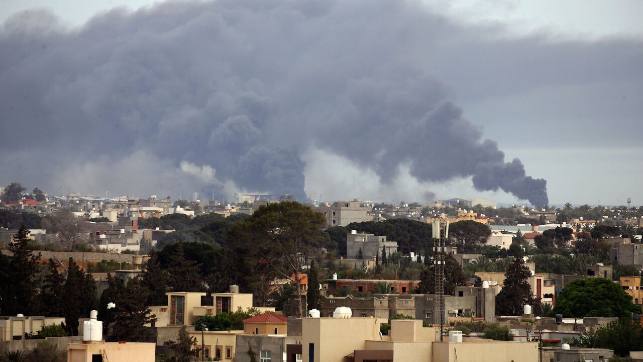 1212250226 Smoke fumes rise above buildings in the Libyan capital Tripoli, during reported shelling by strongman Khalifa Haftar's forces, on May 9, 2020 (Photo by Mahmud TURKIA / AFP) (Photo by MAHMUD TURKIA/AFP via Getty Images)
