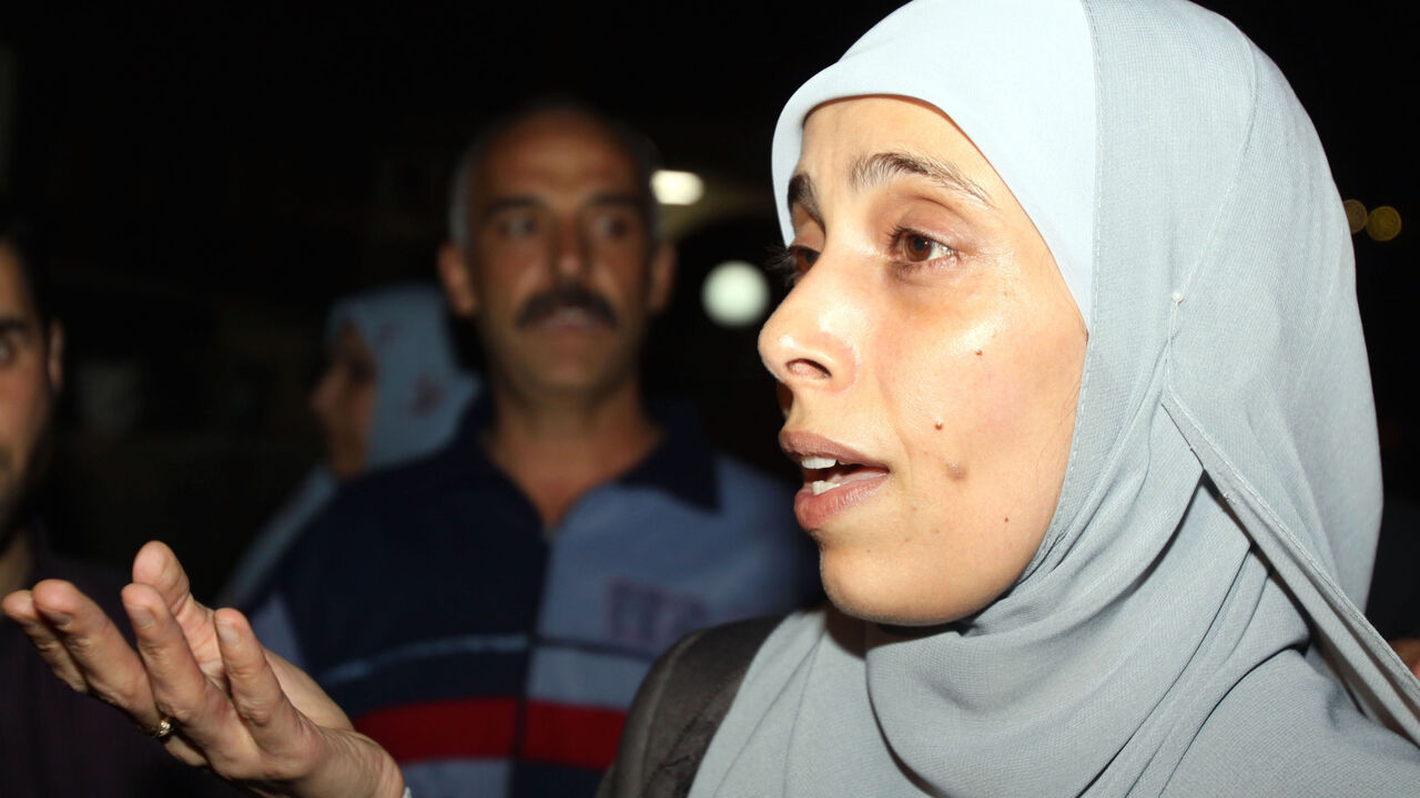 Jordanian freed prisoner Ahlam Tamimi  speaks to reporters upon her arrival at Queen Alia international airport in Amman, late October 18, 2011. Ahlam was sentenced to 16 life terms in jail for her involvement in attacks on the Sbarro Pizzeria in Jerusalem in August 2001. The Palestinian Hamas movement exchanged Gilad Shalit, the Israeli soldier who spent more than five years of isolation in a Gaza hide-out, for hundreds of Palestinian militants being held in Israeli  jails. AFP PHOTO/KHALIL MAZRAAWI (Photo
