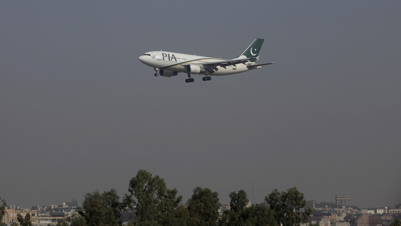 A Pakistan International Airlines (PIA) passenger plane arrives at the Benazir International airport in Islamabad, Pakistan, December 2, 2015. Employees of Pakistan's ailing national airline on December 15, 2015, walked out in protest over its planned privatisation, disrupting flights and undermining a central plank of reforms promised by Prime Minister Nawaz Sharif in return for an IMF bailout. Picture taken December 2, 2015. REUTERS/Faisal Mahmood - GF10000266349