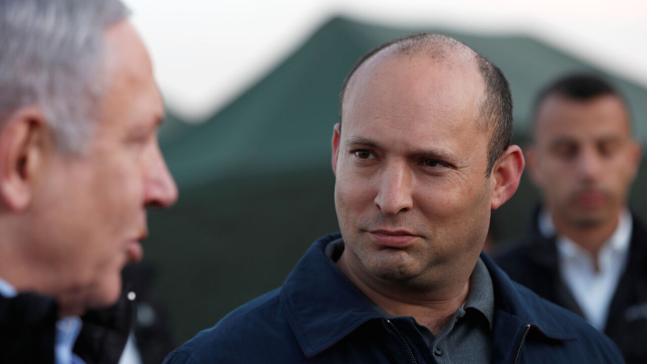 Israeli Defense Minister Naftali Bennett looks at Prime Minister Benjamin Netanyahu during a visit to an Israeli army base in the Israeli-occupied Golan Heights, November 24, 2019. Atef Safadi/Pool via REUTERS - RC2UHD9FXFTH