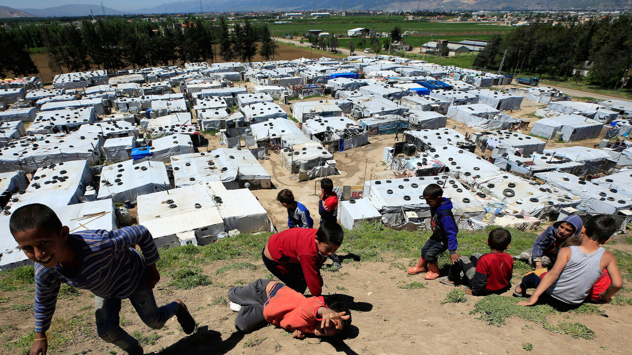 Syrian refugee children play together, as Lebanon extends a lockdown to combat the spread of the coronavirus disease (COVID-19) at a Syrian refugee camp in the Bekaa valley, Lebanon May 7, 2020. Picture taken May 7, 2020. REUTERS/Ali Hashisho     TPX IMAGES OF THE DAY - RC2KLG9KCLMT