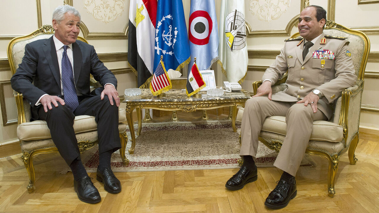 EGYPT/ U.S. Defense Secretary Chuck Hagel (L) sits next to Egyptian Defence Minister General Abdel Fattah Sisi during a meeting at the Ministry of Defence in Cairo April 24, 2013. REUTERS/Jim Watson/Pool (EGYPT - Tags: POLITICS MILITARY) - GM1E94O1K1601