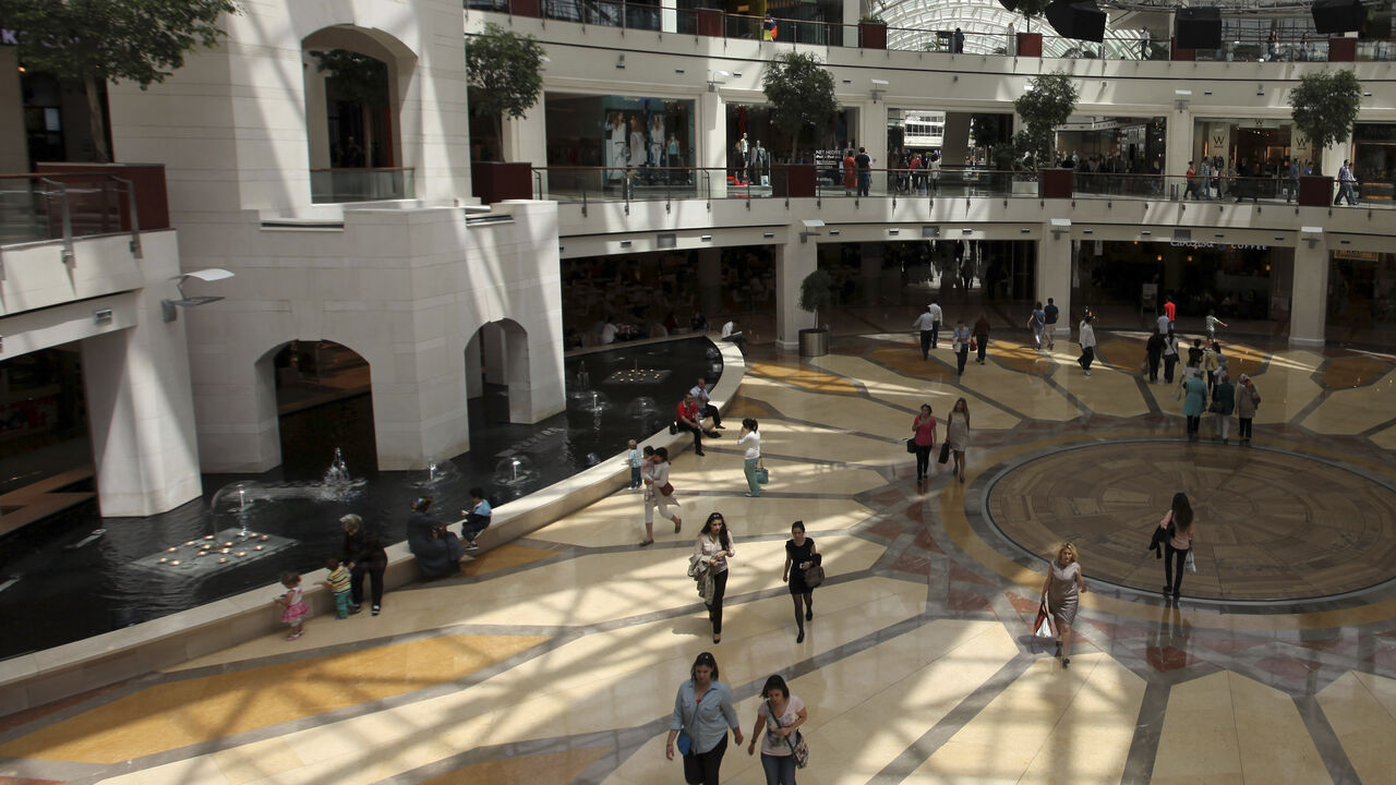 Shoppers walk in Istinye Park shopping mall in Istanbul May 17, 2013. Turkey hailed its second investment grade rating on Friday, seeing it as a seal of approval from international markets for a decade of economic reform. REUTERS/Osman Orsal (TURKEY - Tags: BUSINESS) - GM1E95H1GII01