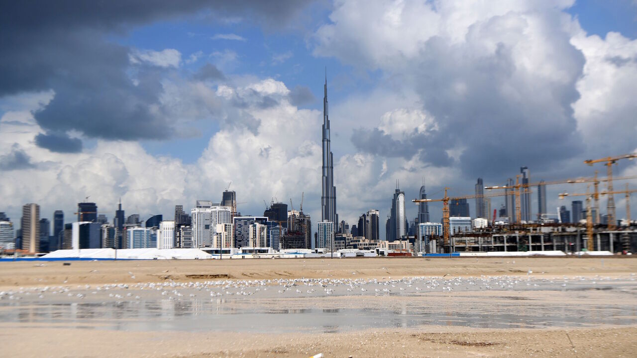 1193191595 A picture taken on January 12, 2020 shows dark clouds over the skyline of Dubai with Burj Khalifa, the worlds tallest building. (Photo by KARIM SAHIB / AFP) (Photo by KARIM SAHIB/AFP via Getty Images)