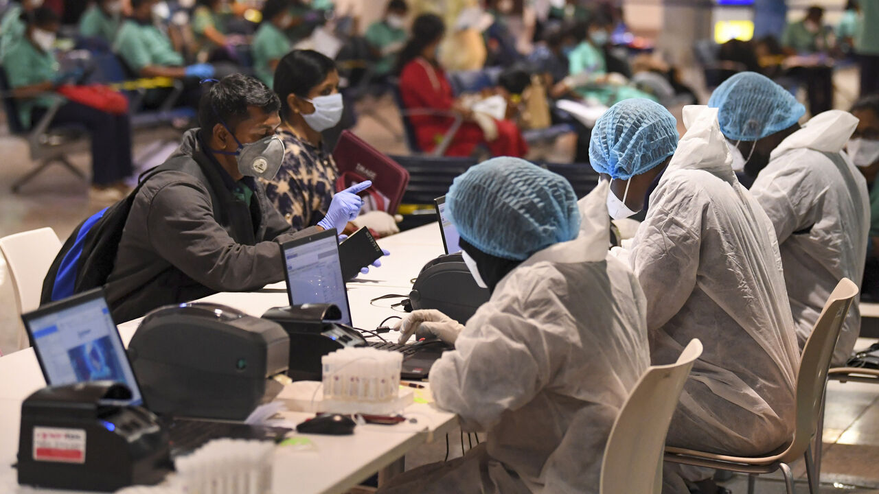 1212432516 Members of an Indian medical team register for testing upon their arrival at Dubai International Airport on May 9, 2020, to help with the coronavirus (COVID-19) pandemic. (Photo by Karim SAHIB / AFP) (Photo by KARIM SAHIB/AFP via Getty Images)