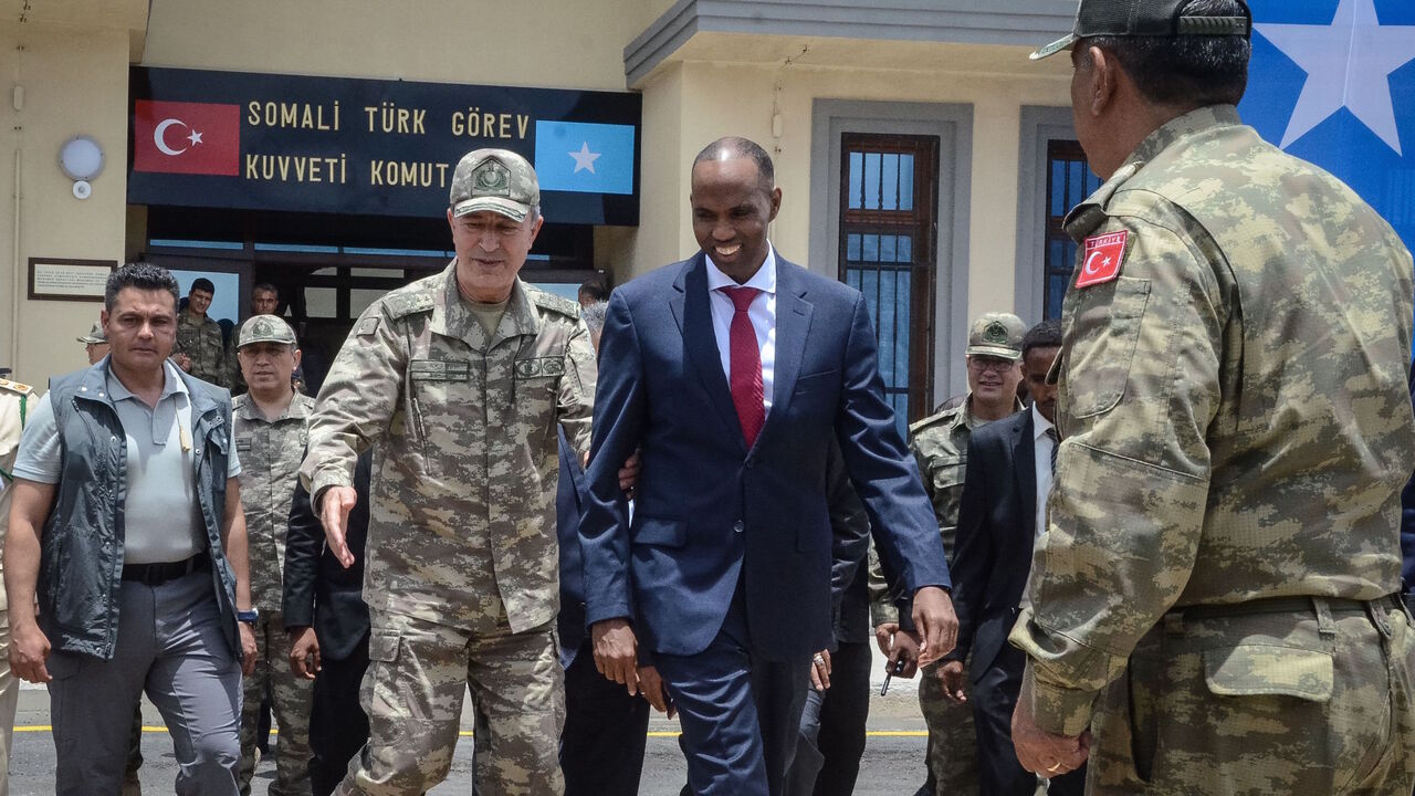 855897216 Turkish army Chief of General Staff Hulusi Akar (L) escorts Somalia Prime Minister Hassan Ali Kheire during an inauguration ceremony of the Turkish military base in Mogadishu on September 30, 2017.
Turkey inaugurated the largest foreign-run military training centre in Somalia, where local troops are due to take over the protection of a nation threatened by Shabaab Islamist attacks. / AFP PHOTO / Mustafa ABDI (Photo credit should read MUSTAFA ABDI/AFP via Getty Images)
