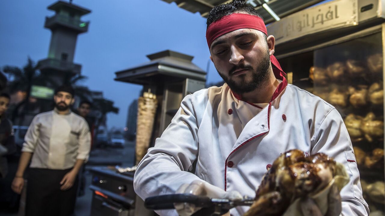 920985028 Syrian refugee Adel Bazmawi, 21, a co-founder and coach of the Syrian Sports Academy, works at a restaurant in Egypt's second city of Alexandria on January 4, 2018.
The academy is squeezed into just 30 square metres (320 square feet), in a modestly equipped hall at the bottom of a residential building in the Alexandria neighbourhood. The academy's founders began the project in 2016 with just 3,000 Egyptian pounds (about $430 at the time).
/ AFP PHOTO / KHALED DESOUKI (Photo credit should read KHALED