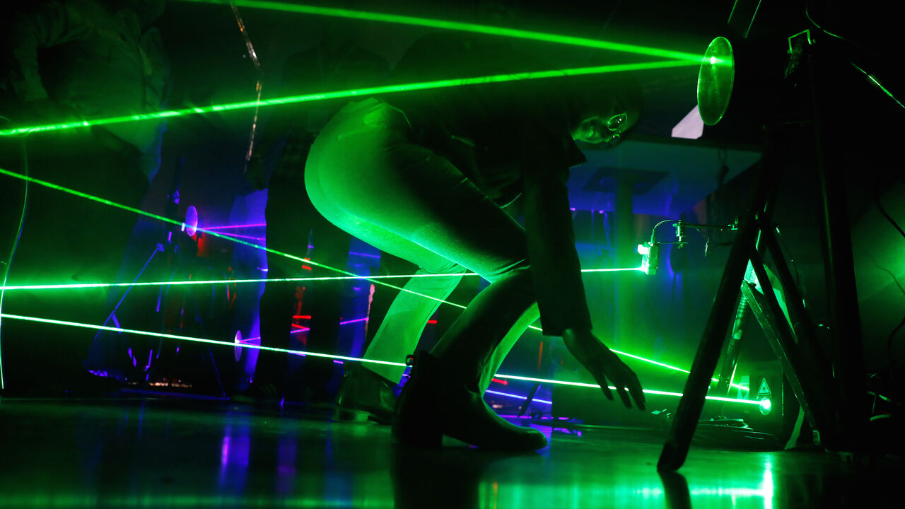 A visitor takes part in a challenge with laser beams at the Israeli police exhibition stand at the Cybertech 2019 conference in Tel Aviv, Israel January 29, 2019. REUTERS/Amir Cohen - RC15E862C4A0