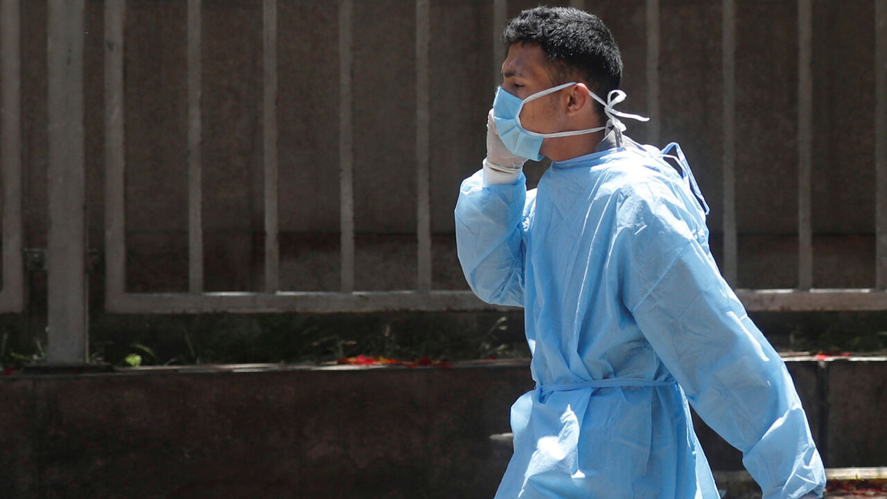 A medical staff member wearing face mask  to prevent the spread of the  coronavirus disease (COVID-19) walks in front of hospital in downtown Cairo, after Egypt's government made wearing masks mandatory in public places and public transport, in Cairo, Egypt May 31, 2020. REUTERS/Amr Abdallah Dalsh - RC2RZG9JH91S