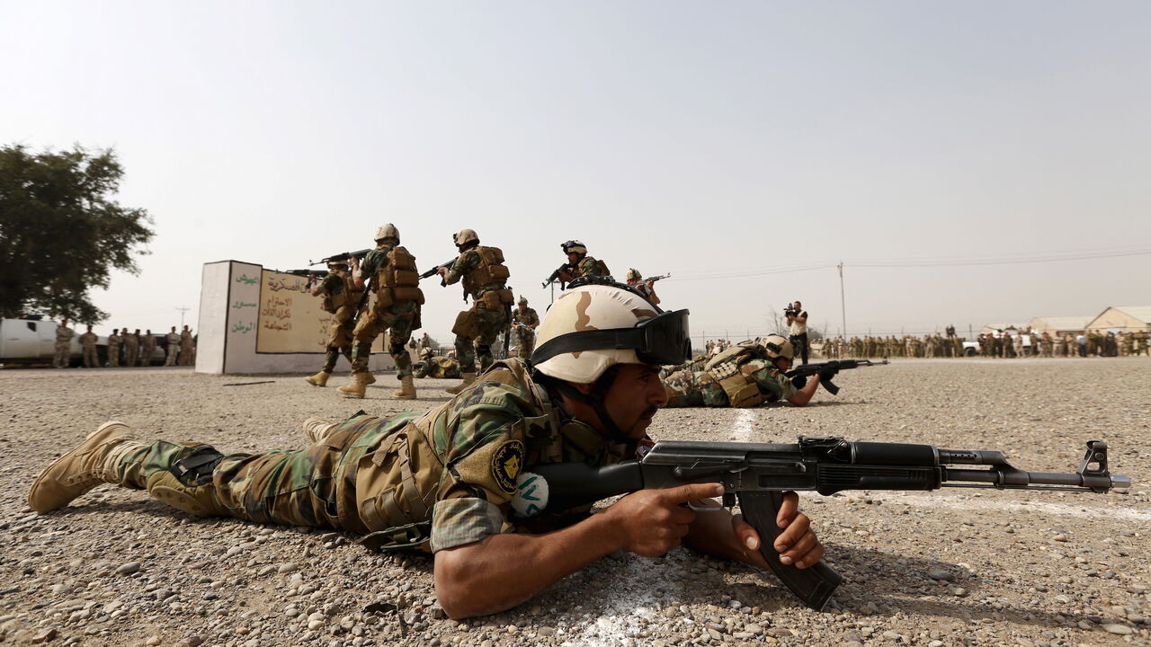 Iraqi security forces demonstrate their skills during a graduation ceremony at an Iraqi army base in Camp Taji in Baghdad, February 21, 2016. REUTERS/Ahmed Saad - GF10000317853