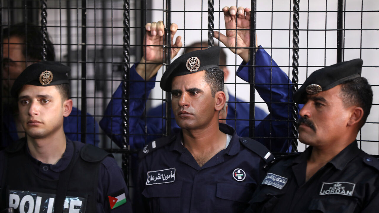 Police officers stand during trial held for over 30 businessmen and customs officials charged with millions of dollars in tax evasion, at the State Security Court, in Amman, Jordan March 12, 2019. REUTERS/Muhammad Hamed - RC179548DF80