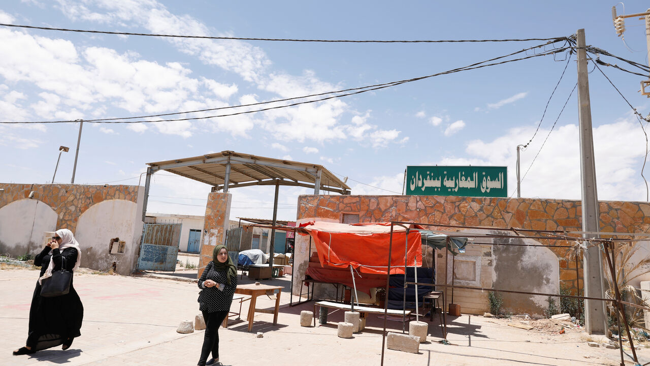 Women walk near "Souk Libya" marketplace in the town of Ben Guerdane, near the Libyan border in Tunisia May 24, 2019. Picture taken May 24, 2019. REUTERS/Zoubeir Souissi - RC1A9F83BA60