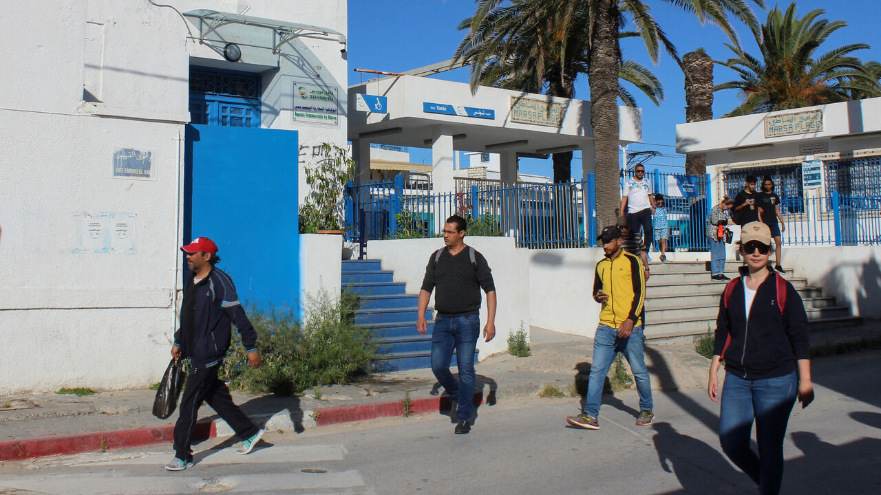 People leave a train station, as Tunisia relaxes some of its lockdown rules while keeping other restrictions in place, as preventive measures against the spread of the coronavirus disease (COVID-19), in La Marsa near Tunis, Tunisia May 11, 2020. REUTERS/Angus McDowall - RC2HMG9VLBYJ