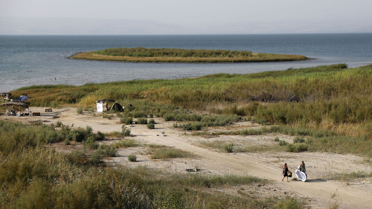 1025296480 People gather near an island that was exposed due to low water level in the Sea of Galilee in northern Israel on August 30, 2018. (Photo by AHMAD GHARABLI / AFP) (Photo credit should read AHMAD GHARABLI/AFP via Getty Images)
