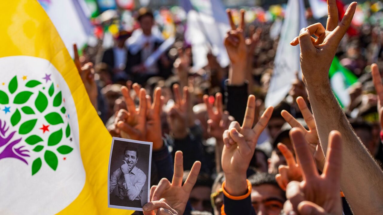 1132476804 TOPSHOT - Supporters of Turkey's main pro-Kurdish People's Democratic Party (HDP) party cheer as they celebrate the Kurdish New Year during a campaign rally in Istanbul on March 24, 2019 ahead of the March 31 local elections. - Under daily attack from Turkish President and with dozens of its mayors in jail, HDP is fighting an uphill battle for this month's local elections and hopes to mobilise its supporters in the vote to capture municipal mayor posts and local councils. (Photo by Yasin AKGUL / AFP)