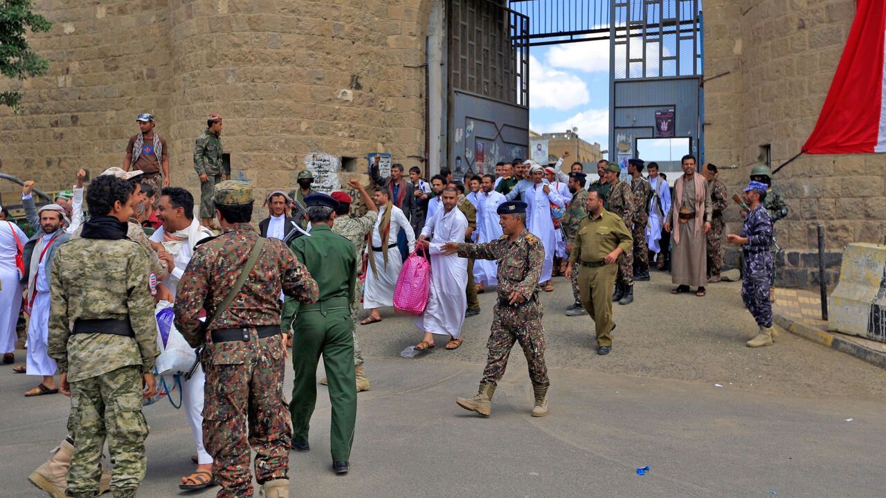 1172529138 Yemeni prisoners, said to belong the Saudi-backed government forces, react following their release by the Huthi rebels from the central prison in the capital Sanaa before being handed over to their families on September 30, 2019. - Yemen's Huthi rebels have freed 290 prisoners, including dozens of survivors from a Saudi-led coalition strike on a detention centre earlier this month, the ICRC said. The International Committee of the Red Cross hailed the move as "a positive step that will hopefully revive the