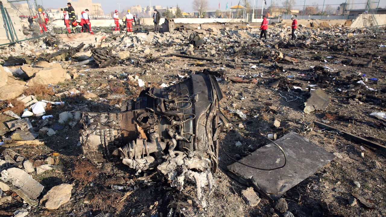 1192511974 TOPSHOT - Rescue teams work at the scene after a Ukrainian plane carrying 176 passengers crashed near Imam Khomeini airport in the Iranian capital Tehran early in the morning on January 8, 2020, killing everyone on board. - All 176 people on board a Ukrainian passenger plane were killed when it crashed shortly after taking off from Tehran on January 8, Iranian state media reported. State news agency IRNA said 167 passengers and nine crew members were on board the aircraft operated by Ukraine International A