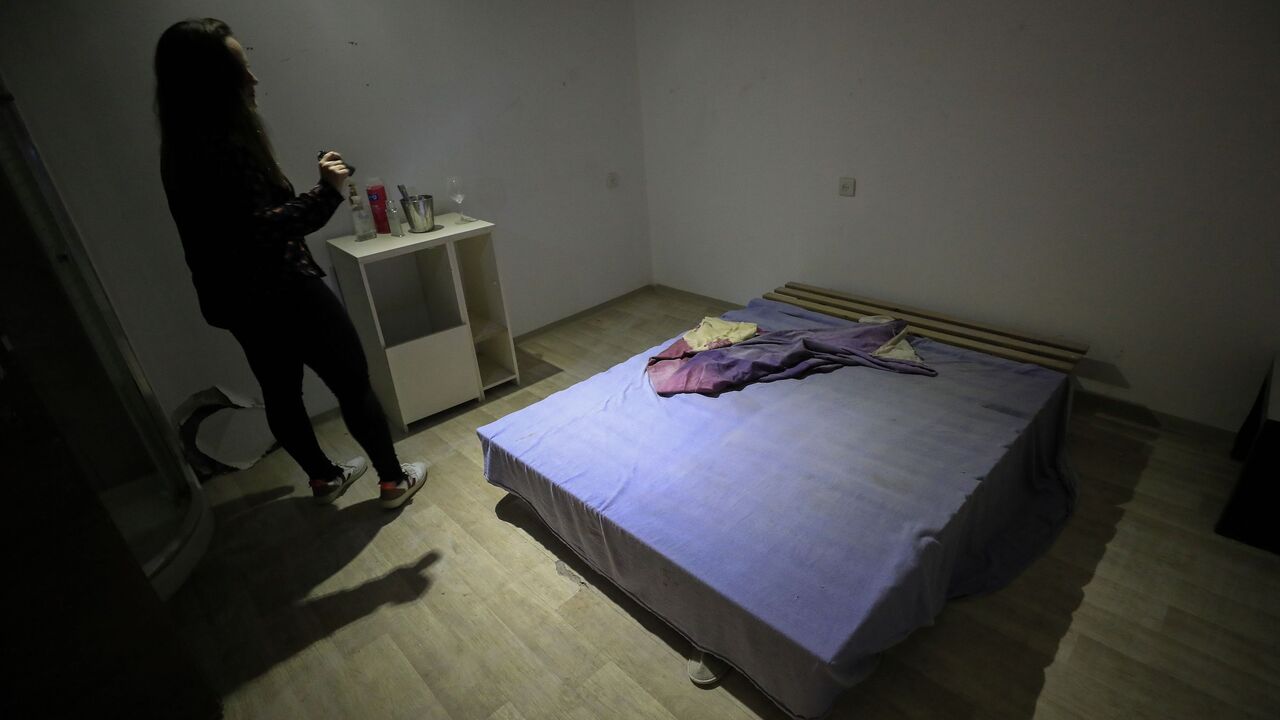 1211647606 A woman visits a room in the undergrounds premises of the former Pussycat strip club, turned into a local NGOs community centre and small museum, in the coastal Mediterranean city of Tel Aviv on March 5, 2020. - The demise of Tel Aviv's strip clubs was accelerated in 2018, when Israel's parliament, the Knesset, passed a law banning brothels. But the final straw came in April last year when the public prosecutor issued a directive to clamp down on lap dances, arguing they could in some cases be viewed as pro