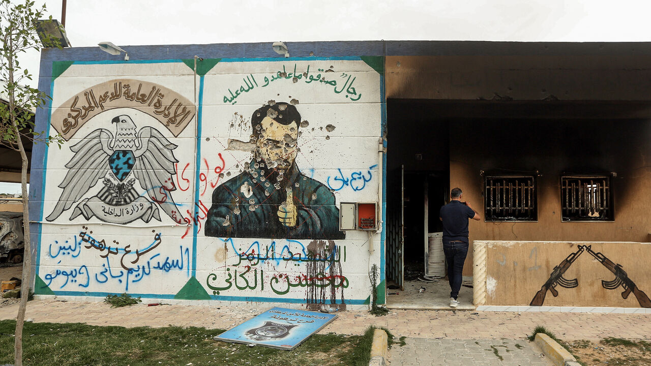 1219320982 This picture taken on June 11, 2020 shows a view of a mural depicting Mohsen al-Kania a commander of forces loyal Libya's eastern strongman Khalifa Haftar drawn on the wall of a detention facility formerly controlled by them, which fell into the control of security forces affiliated with the Libyan Government of National Accord (GNA)'s Interior Ministry in the town of Tarhuna, about 65 kilometres southeast of the capital Tripoli. (Photo by Mahmud TURKIA / AFP) (Photo by MAHMUD TURKIA/AFP via Getty Images)