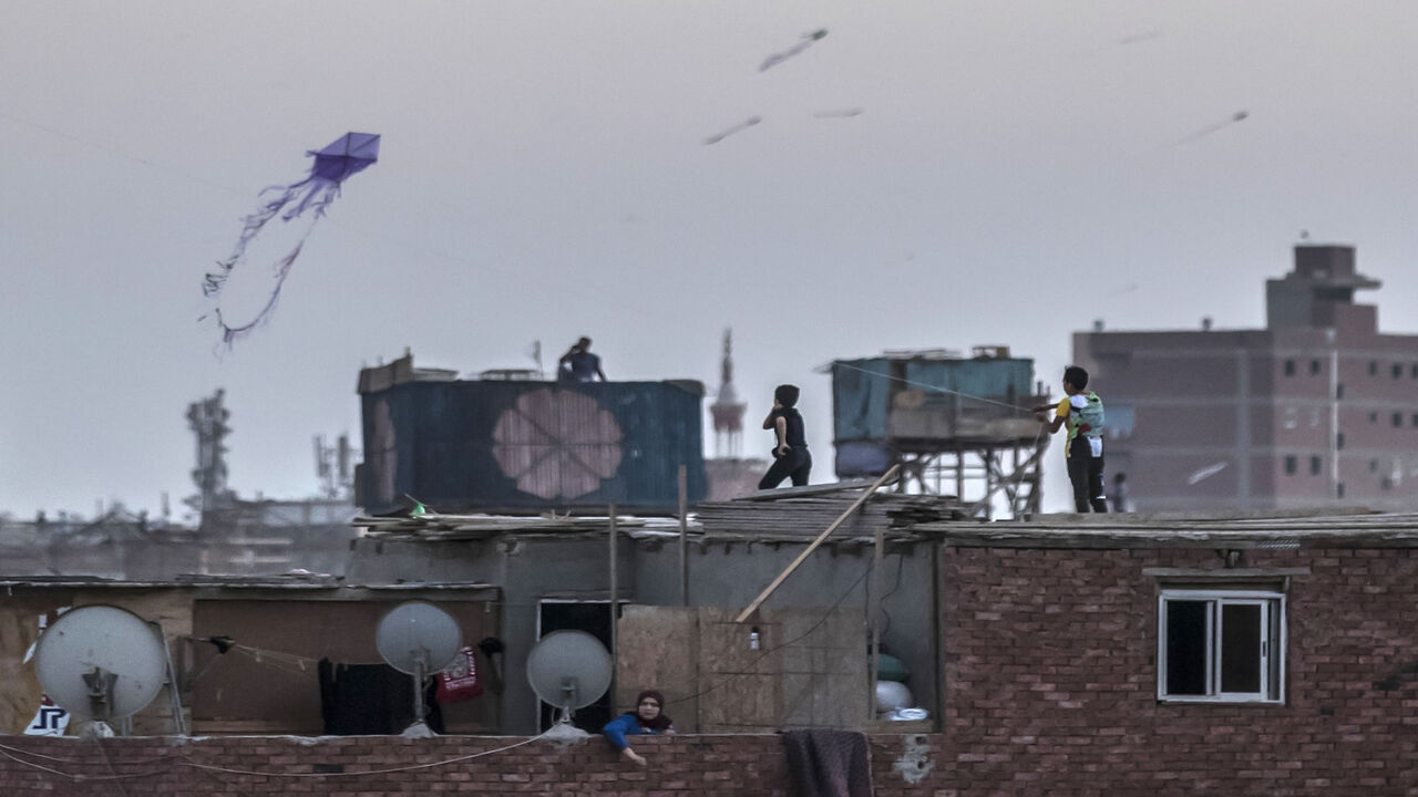 1220234915 Egyptian youths fly kites in the Saft el-Laban district of the Egyptian capital Cairo's twin city of Giza on June 15, 2020. (Photo by Khaled DESOUKI / AFP) (Photo by KHALED DESOUKI/AFP via Getty Images)
