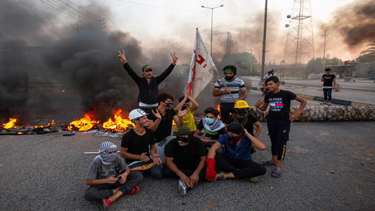 1227113149 Demonstrators block a road during a protest in the southern city of Basra on July 14, 2020, as protesters gathered to denounce the lack of electricity and services. (Photo by Hussein FALEH / AFP) (Photo by HUSSEIN FALEH/AFP via Getty Images)