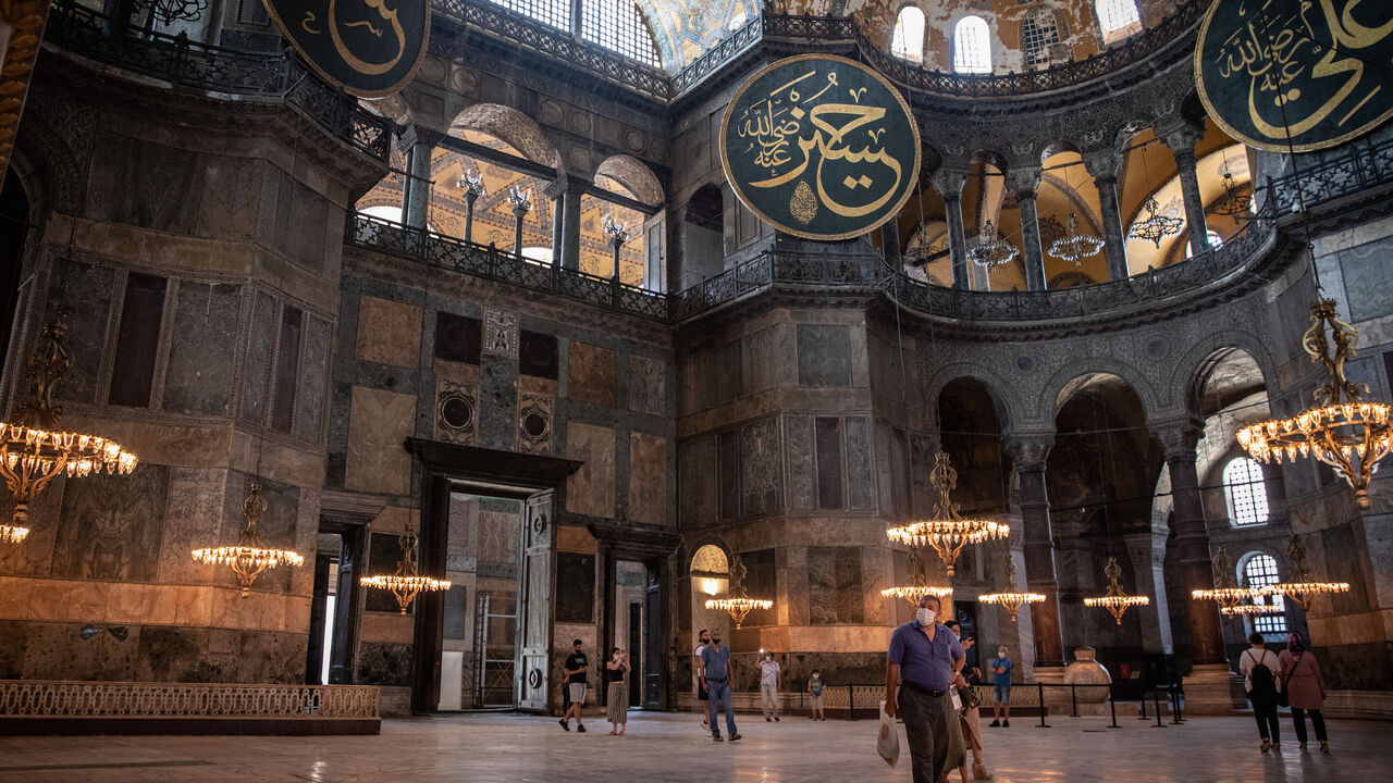 1253859377 ISTANBUL, TURKEY - JULY 02: Tourists visit Istanbul's famous Hagia Sophia on July 02, 2020 in Istanbul, Turkey. Turkey's Council of State will begin a review today of the building's status and the possibility of changing it from a museum, back into a mosque upon the request of nationalist and religious groups. Throughout it's history the UNESCO World Heritage site has served as a Byzantine Cathedral, a mosque under Ottoman rule and now a museum, after a 1934 decision led by modern Turkey's founder Mustafa K