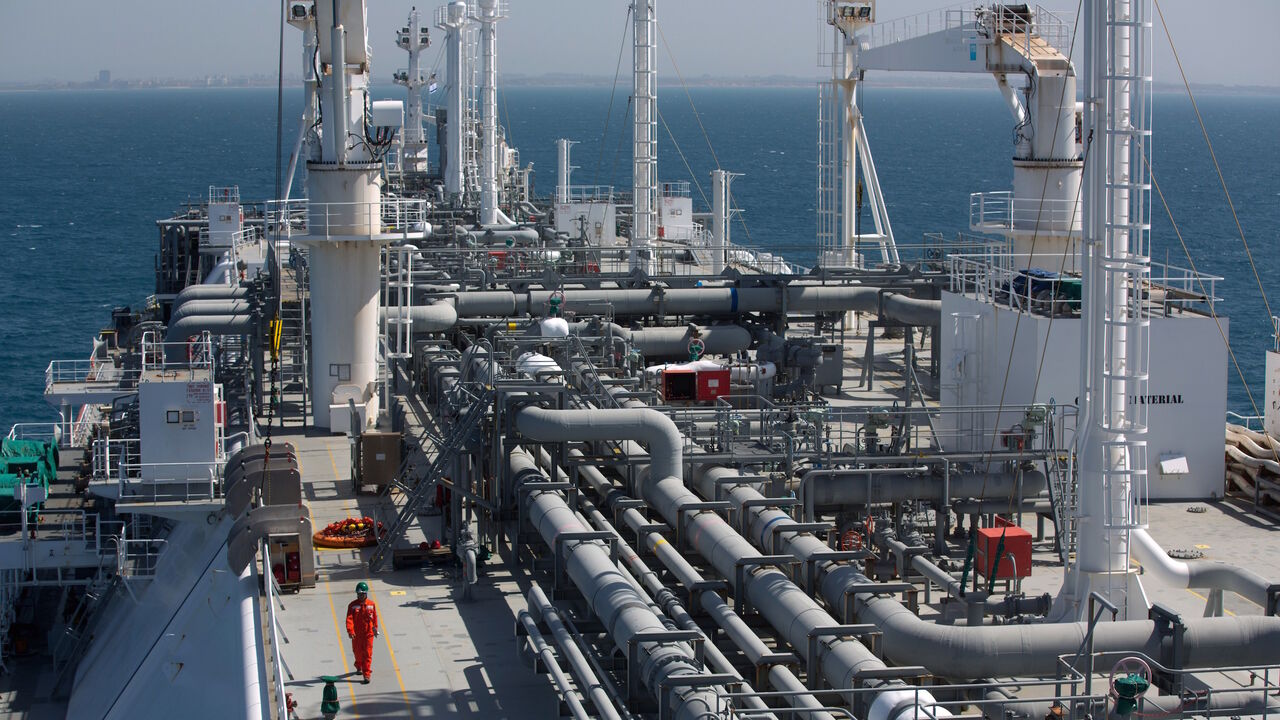 464507066 An employee walks on the Expedient regasification ship, anchored off the coast of Israel in the Mediterranean Sea on February 26, 2015, as natural gas began flowing from the vessel, hired by the Israel Electric Corporation, to its power stations. The ship, anchored about ten kilometres from the Hadera coast, was connected the previous week to the marine buoy and as of February 25, natural gas has begun flowing from the LNG (liquid natural gas) ship through an underwater pipeline directly to the company's po